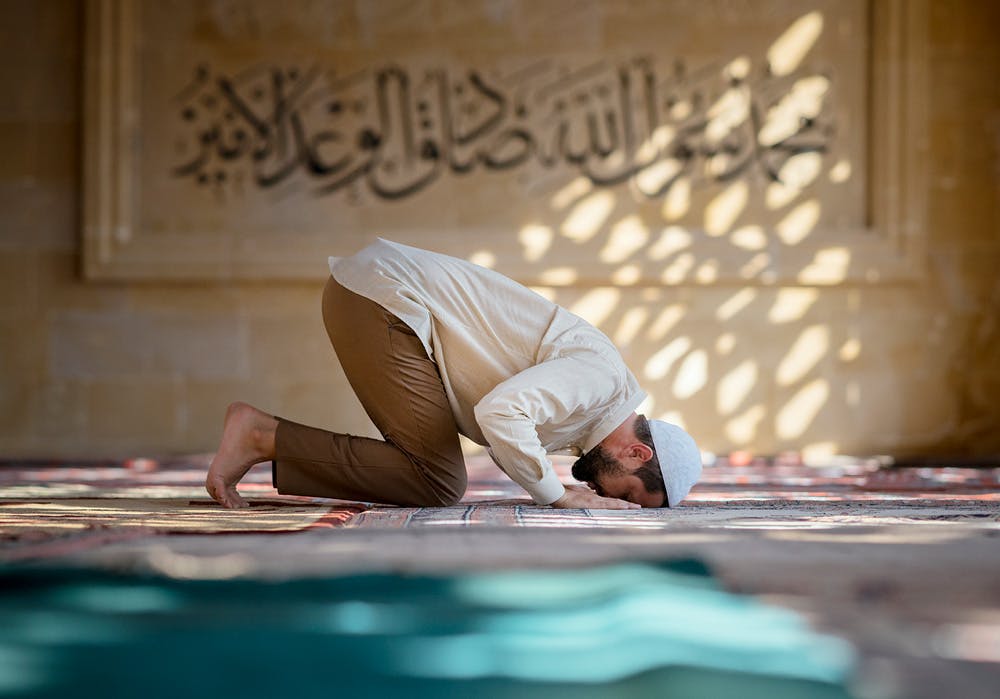 A man pray on a prayer mat